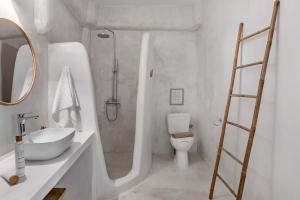 a bathroom with a shower and a sink and a toilet at Horizon House with private pool and breathtaking views in Andiparos