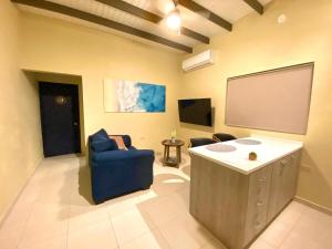 a large room with a large screen and a chair at Aruba IXORA Suites in Noord +8 photos