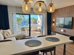 a living room with a table with chairs and a couch at Callao Ocean View Luxury, air condition, wifi in Callao Salvaje