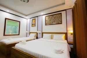 Postel nebo postele na pokoji v ubytování Vientiane Ruby Riverside Hotel
