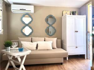 a living room with a couch and a table at Mini Estudio Málaga in Málaga