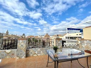a balcony with a table and a view of a city at Mini Estudio Málaga in Málaga
