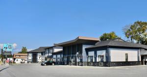 a row of buildings in a parking lot at Big Bird Inn Wawa, SureStay Collection by Best Western in Wawa