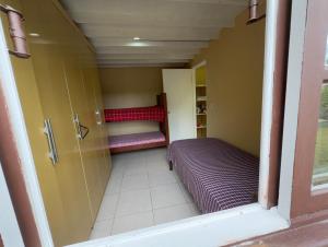 a small room with two bunk beds in it at Rosa blue in Imbituba