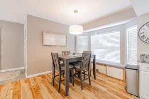 a dining room with a table and chairs and a clock at Vibrant Boho Home 3 Bed Pet Friendly in Reno +15 photos