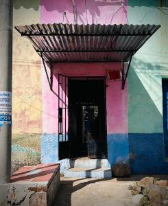 a building with a black door and a colorful wall at La Casita de Nataly in Santa Ana +3 photos