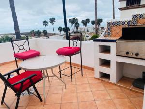a balcony with a table and two chairs and a grill at Real Del Mar Tijuana Apt for 2 guests in Tijuana