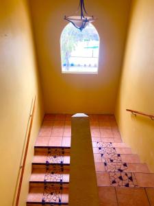 a room with a staircase with a window and a window at Real Del Mar Tijuana Apt for 2 guests in Tijuana