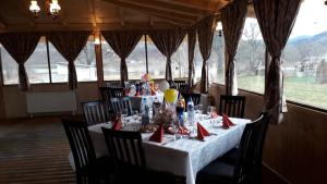 a dining room with a long table with red napkins at La Amy in Pangarati