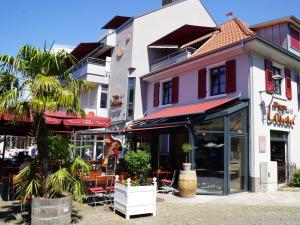 a group of buildings with tables and chairs at Apartments zum roten Lamm- Bad Krozingen by living TIMELESS in Bad Krozingen
