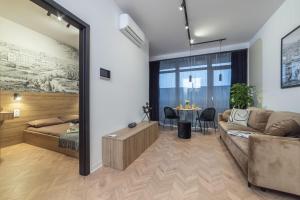 a living room with a couch and a table at Premium Apartamenty Grunwaldzka 25A in Bydgoszcz