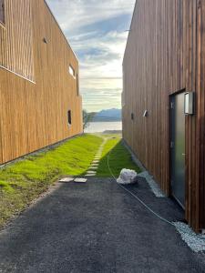 a hallway between two buildings with a view of the water at Nordheim studio apartment Close to sea nature and city center in Tromsø +5 photos