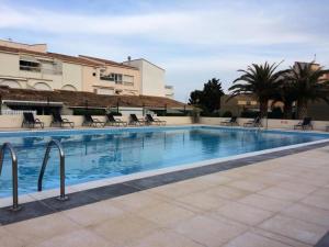 duży basen z krzesłami przed budynkiem w obiekcie Résidence Port Soleil Bâtiment B3 - Studio Cabine 2 pers. Port Soleil CAP d'AGDE MAE-4424 w Cap d'Agde