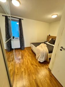 a bedroom with a bed and a large window at Apartment near Oslo, Drammen, and a lake in Lier