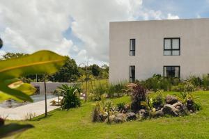 a white building with a garden in front of it at Casa Bodhi in Santa Catalina