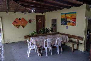 a dining room table and chairs in a room at Pousada garopaba in Garopaba