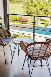 a patio with two chairs and a table on a balcony at Casa Bodhi in Santa Catalina +24 photos