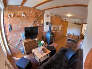 a living room with a brick wall at Alpha Ski Apartmani in Jahorina