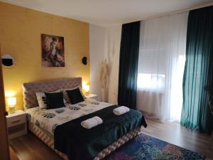 a bedroom with a bed with two towels on it at Apartman Raj in Vrnjačka Banja
