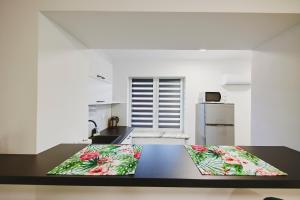 a kitchen with a table with flowers on it at Wesoła Centrum in Suwałki