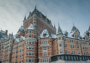 a large red brick building with turrets at Quebec Grand Appartement by Hébergements DCL in Quebec City