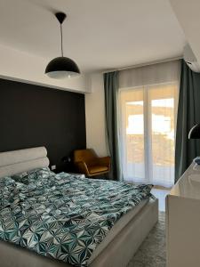 a bedroom with a bed and a window at CityCenter Heart - Ultracentral & Panoramic View in Reşiţa