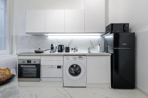 a kitchen with a refrigerator and a washing machine at Cosy Studio, close to Monaco Train Station in Beausoleil +16 photos