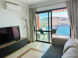 Televízia a/alebo spoločenská miestnosť v ubytovaní Su Eminencia - Sea View Apartment with Modern Comforts