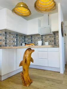a wooden animal in the middle of a kitchen at Studio Méditerranéen in Corneilla-del-Vercol