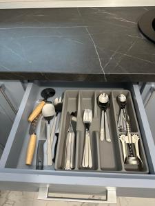a kitchen sink with utensils in a drawer at Toscana Apartments in Otopeni +133 photos