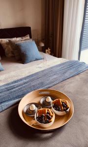 a plate with three muffins and eggs on a bed at Residence in Belgrade