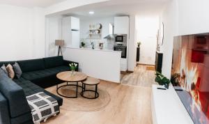 a living room with a green couch and a table at Apartment Friday in Travnik