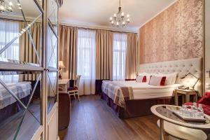 a hotel room with a bed and a table at Pushka INN hotel in Saint Petersburg +37 photos
