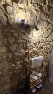 a room with a stone wall and a shelf with towels at Il Richiamo della Cascata in Papigno +42 photos