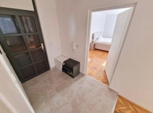 a hallway with a door and a room with a bed at Avdina Luxury Apartment in Sarajevo