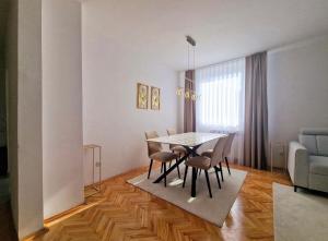 a dining room with a table and chairs at Avdina Luxury Apartment in Sarajevo +5 photos