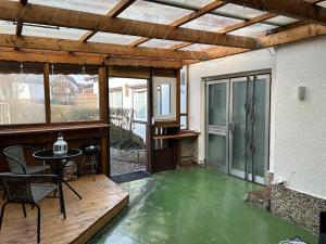 a patio with a green floor and a table at Haus Sösetal in Osterode am Harz in Osterode