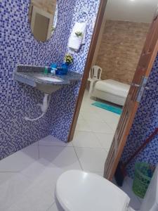 a bathroom with a toilet and a sink and a mirror at Chalés Luz do Luar in Aracati