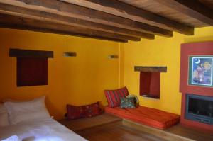 a bedroom with two beds and a fireplace at Anemi in Káto Pediná