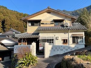 ein Haus mit einem Zaun davor in der Unterkunft Okawachiyama LODGE - Village of the Secret Kilns! in Imari