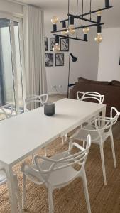 a white dining table and chairs in a living room at CITY STAYS BELÉM APARTMENTS in Lisbon