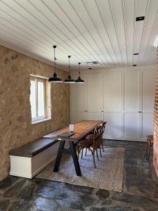a dining room with a wooden table and chairs at Oxenberry Farm in McLaren Vale