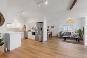 a kitchen and a living room with a refrigerator at Bonny Chill - Walk to beaches, pet friendly in Bonny Hills