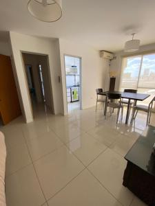 a living room with a table and chairs in it at Dpto 9 DE JULIO in Villa María