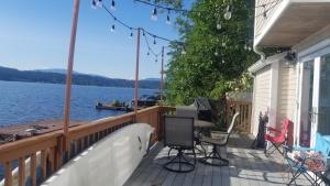 a porch of a house with a view of the water at Lakefront with private beach in Redmond