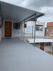 a building with awning on top of a patio at Vila do Chaves Casa da Popis 23 in Itajaí