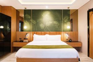 A bed or beds in a room at Ironwood Hotel