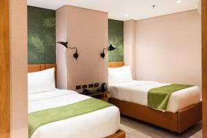 A bed or beds in a room at Ironwood Hotel