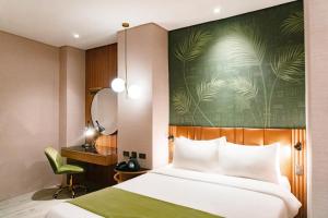 A bed or beds in a room at Ironwood Hotel