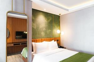 A bed or beds in a room at Ironwood Hotel
